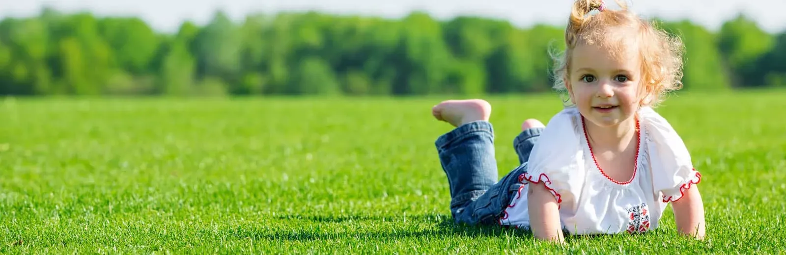 Girl playing in green grass